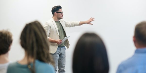 man presenting in front of people